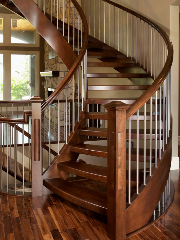 Curved open rise staircase with round stainless steel spindles.