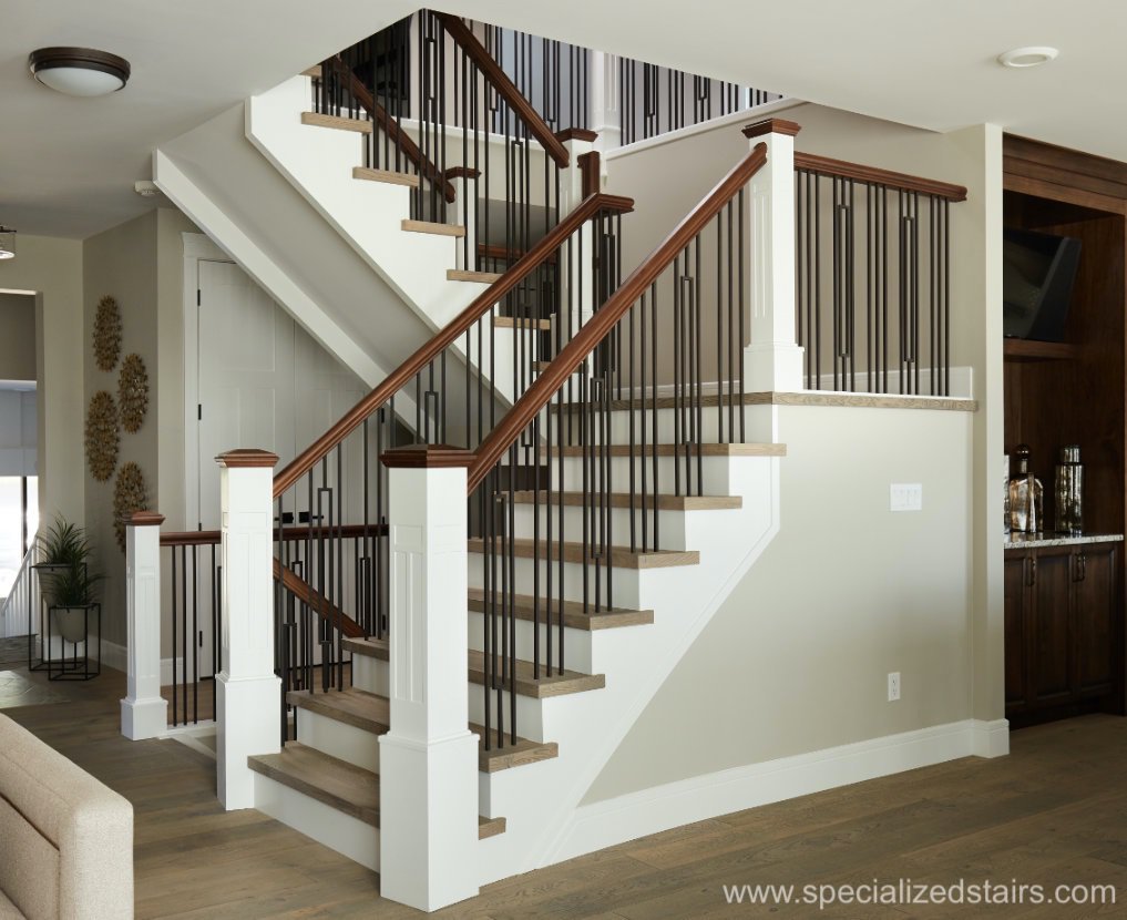 closed rise eastern flare staircase with craftsman feature newel posts, iron spindles, and walnut handrail. 