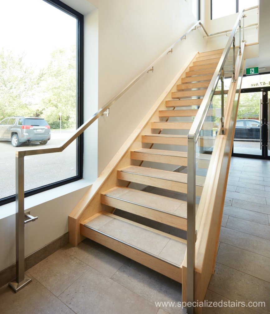 A solide maple open rise straight run staircase with tile inlay, stainless steel handrail and clamped glass railing.