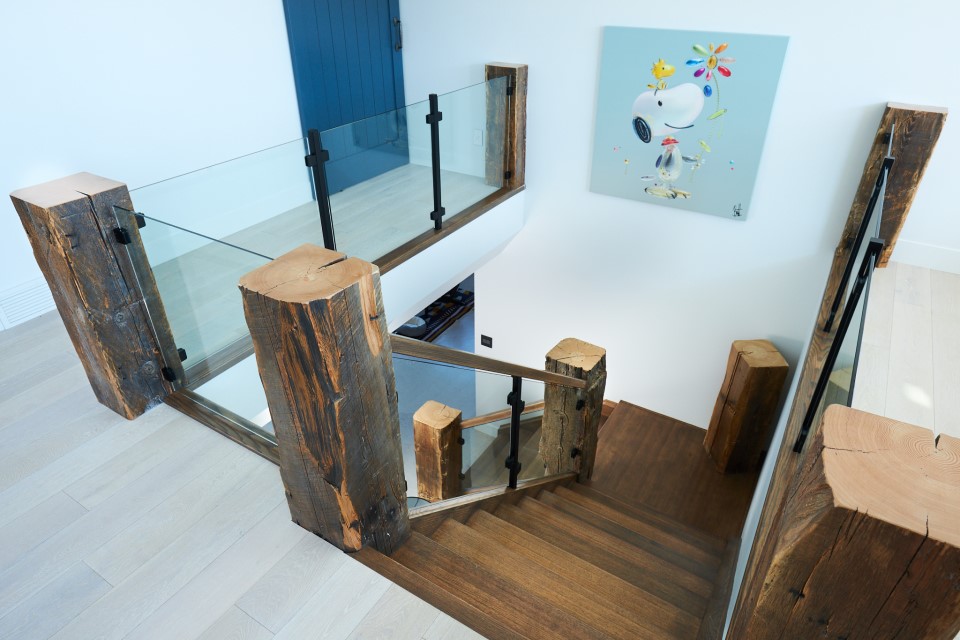modern rustic railing with reclaimed timber posts and clamped glass railing