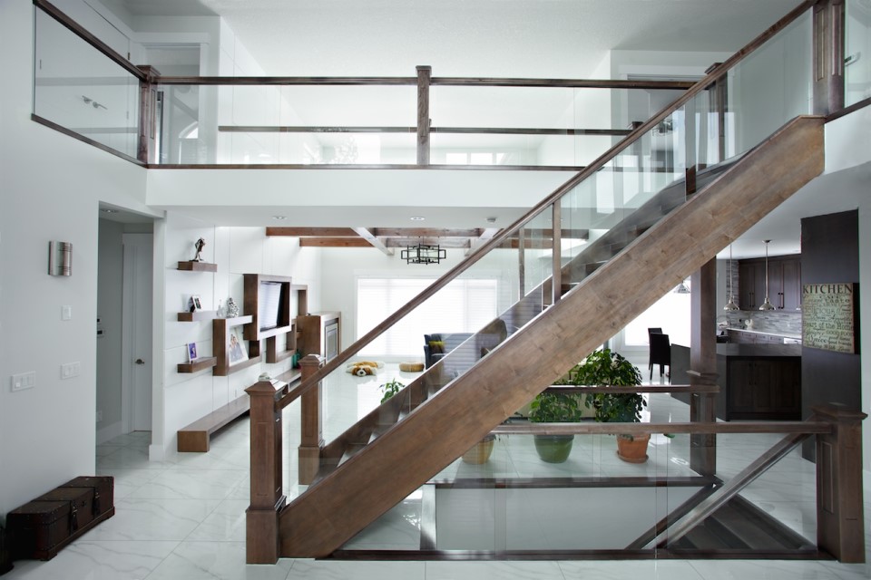 Open rise maple stair with dadoed glass railing and maple handrail