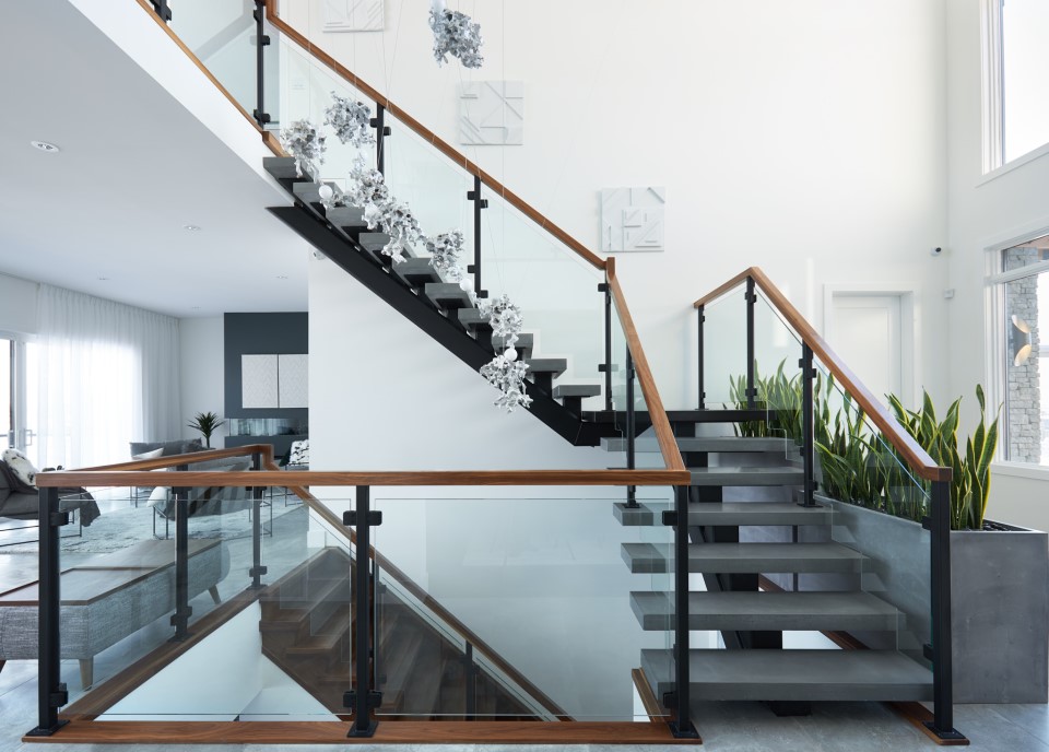 concrete and steel mono stringer with clamped glass railing and walnut railing