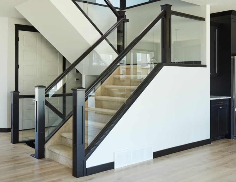 straight run staircase with carpet treads and a modern dadoed glass railing system