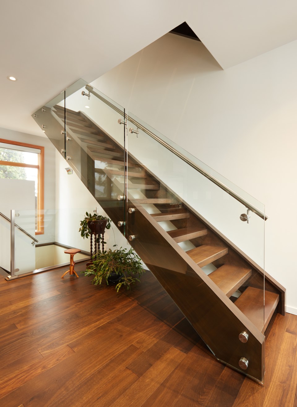 white oak open rise straight run staircase with glass railing and stainless steel handrail